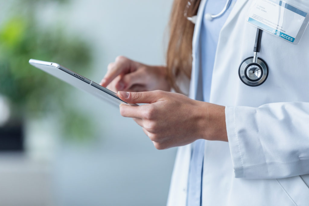 female doctor using her digital tablet in the office
