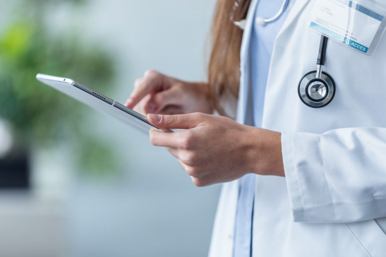 female doctor using her digital tablet in the office